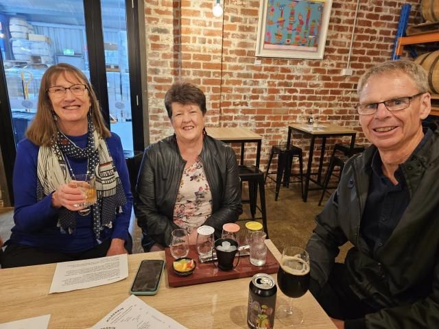 Jennifer, Clare and Mark with a tasting paddle & beer